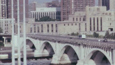 16-mm-Farbfilm-Eines-Busses,-Der-über-Eine-Brücke-In-Richtung-Einer-Stadt-Fährt