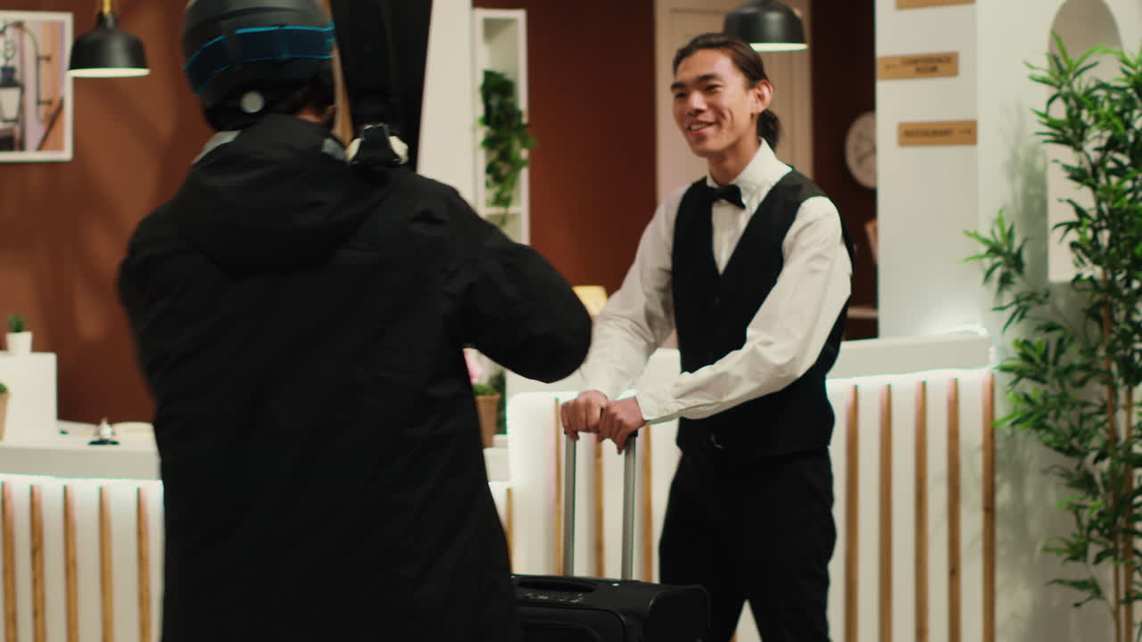 Workers welcoming traveller at hotel