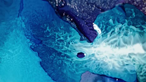 Blue-and-white-ink-creating-abstract-patterns-in-water,-dynamic-swirling-motion-captured-in-high-detail