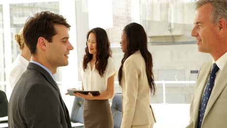 Businessmen-talking-together-and-shaking-hands