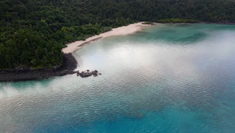 aerial view of white sand beach by the calm blue sea - hook passage and hook island in whitsunday, qld, australia