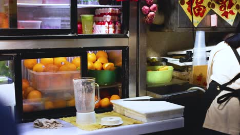 worker preparing fruit drinks at a shop