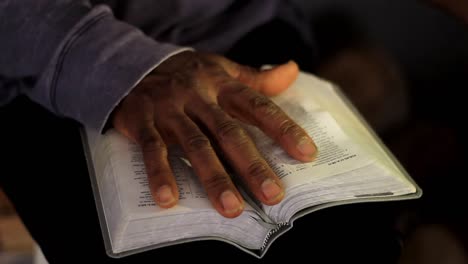 praying to god with hand on bible with grey background stock video