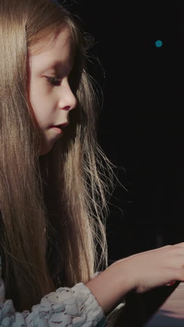 charming girl operates digital piano