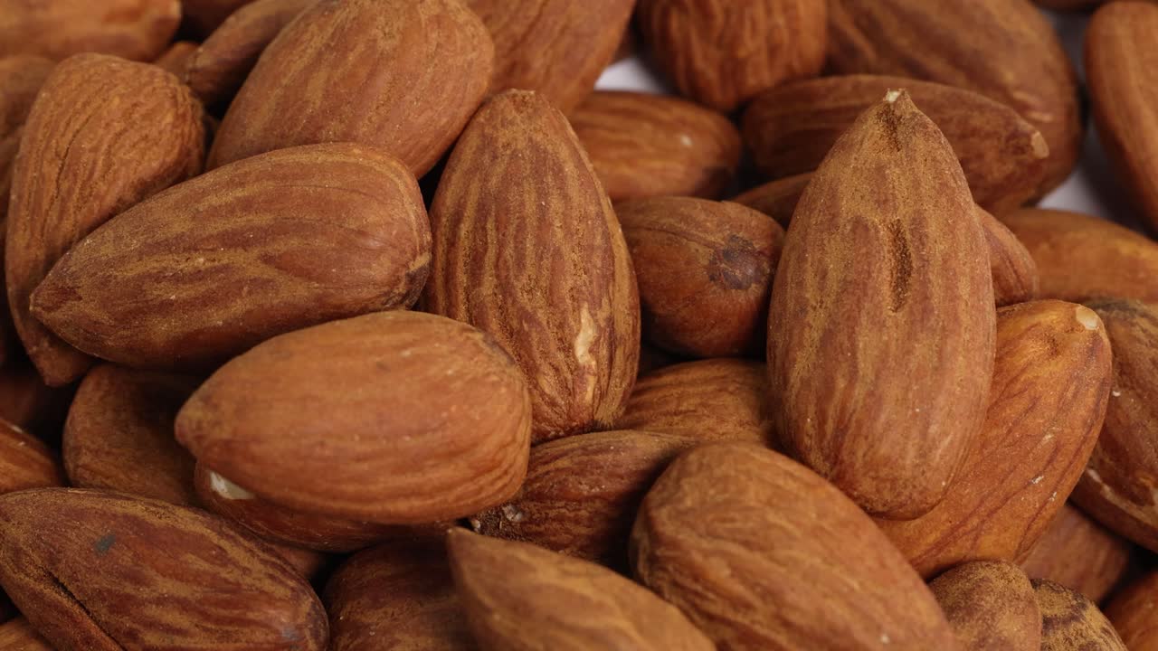 A detailed macro view of almonds, highlighting texture and natural color under soft lighting