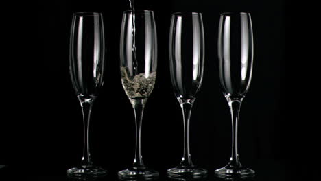 champagne flowing in super slow motion in flutes