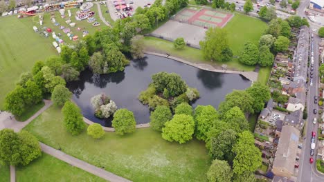 Aerial-shot-rising-over-a-lake-and-trees-in-the-beautiful-English-countryside