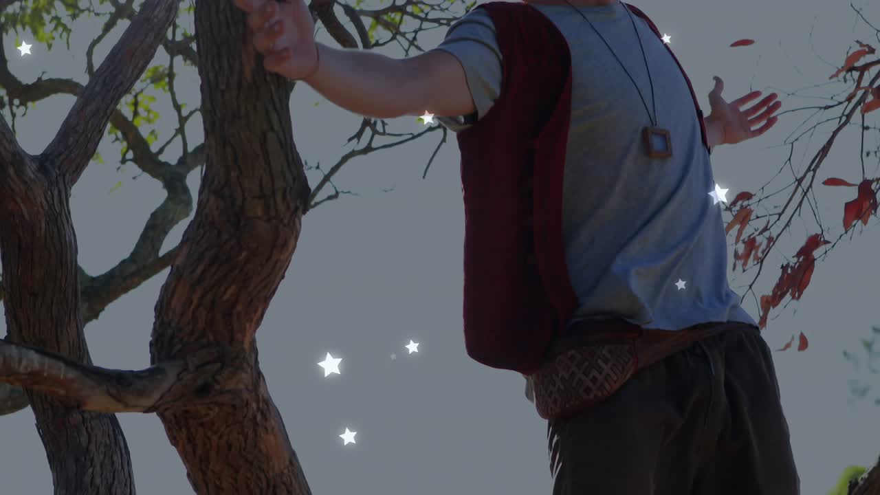 Man touching tree trunk, straightening, opening arms while sparkles rising around him for marketing