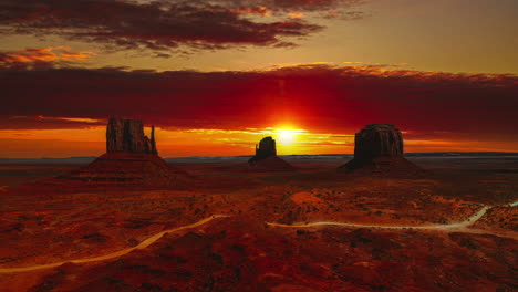 Cinemagraph---seamless-video-loop-of-a-golden-red-cloud-sunset-time-lapse-at-the-famous-Mitten-Butte-tea-kettle-rocks-among-the-Monument-Valley-landmarks-in-Utah---Arizona,-America---USA