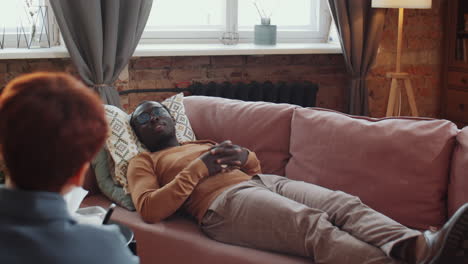 African American Man Lying on Couch during Therapy Session with Psychologist