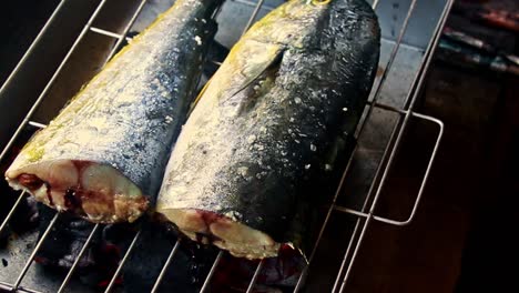 overhead view of a fish sinugba or inihaw on a charcoal grill, authentic traditional local filipino dish from the philippines