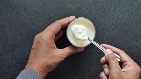 Glass-of-whole-cream-milk-on-table-,