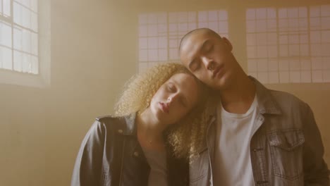 fashionable young man and woman in an abandoned warehouse