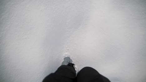 A-man-stomps-through-the-snow.-POV-perspective