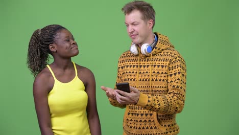 young multi-ethnic couple using phone together