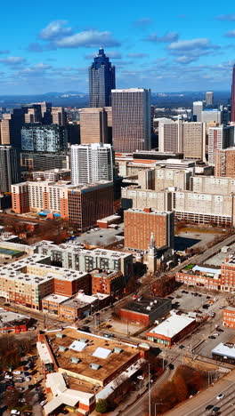 urban landscape of modern american city downtown. daytime scenery of atlanta, georgia, usa from aerial perspective. vertical video
