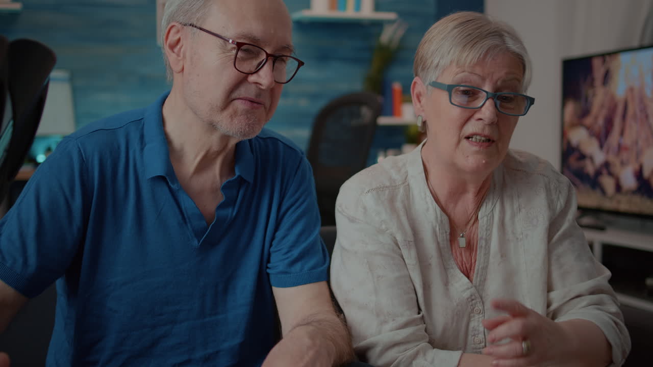 Elderly couple video conferencing on a laptop