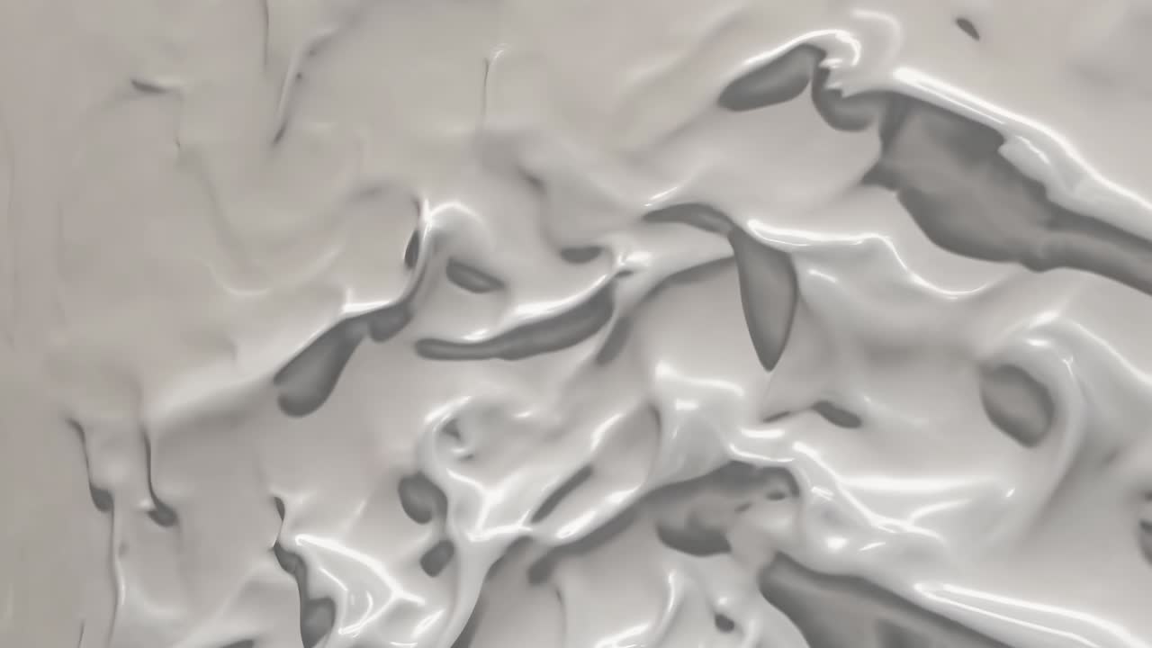 Abstract video with a close-up angle of flowing, glossy, white liquid texture