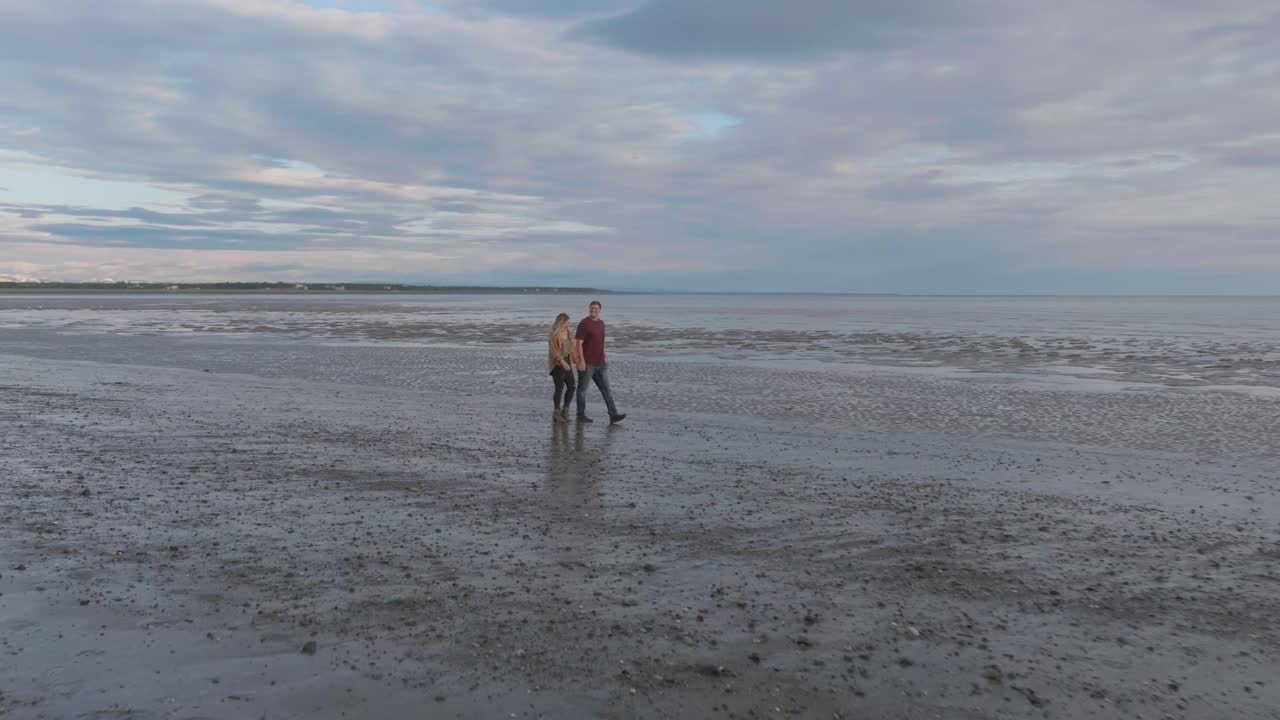 Couple walking on beach in Kenai, Alaska
