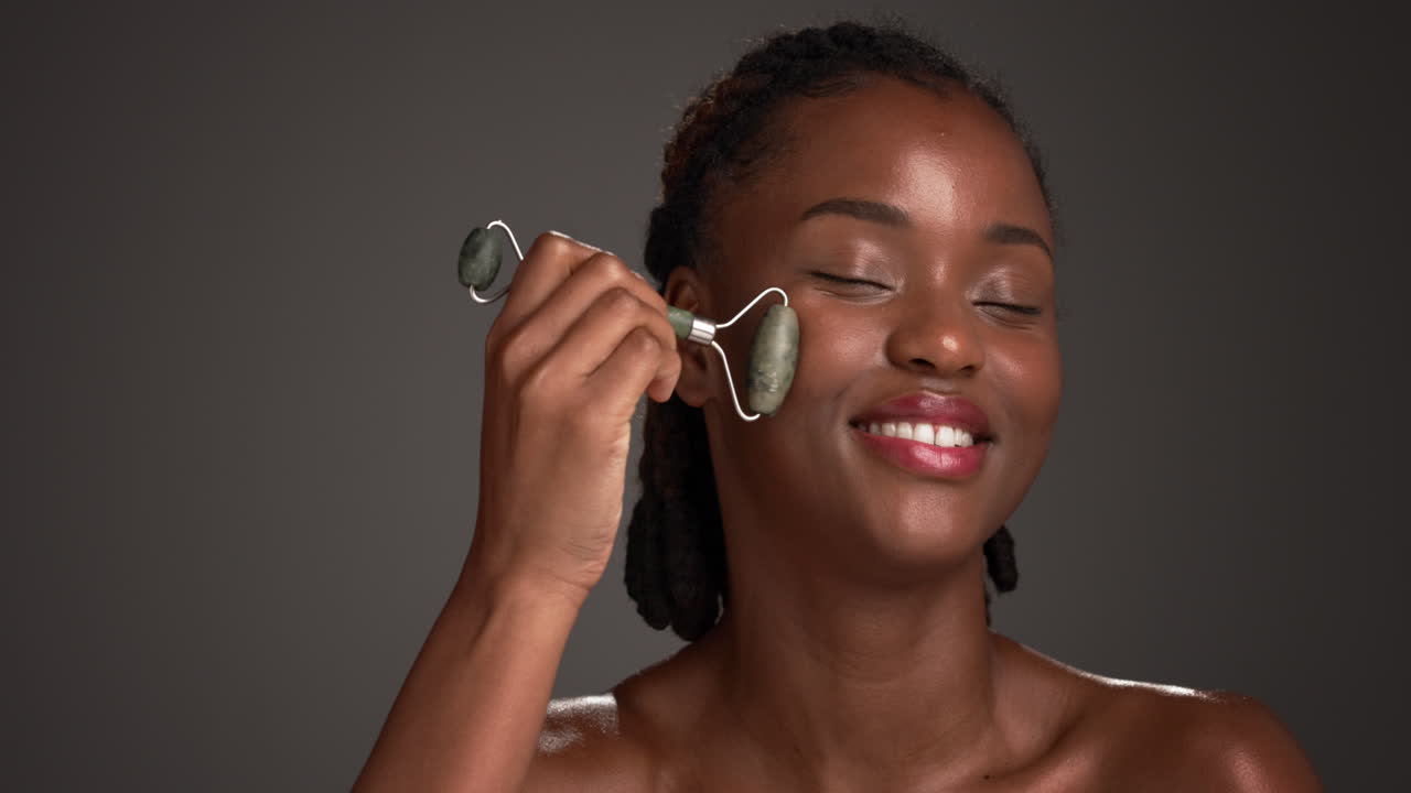 Woman using jade face roller