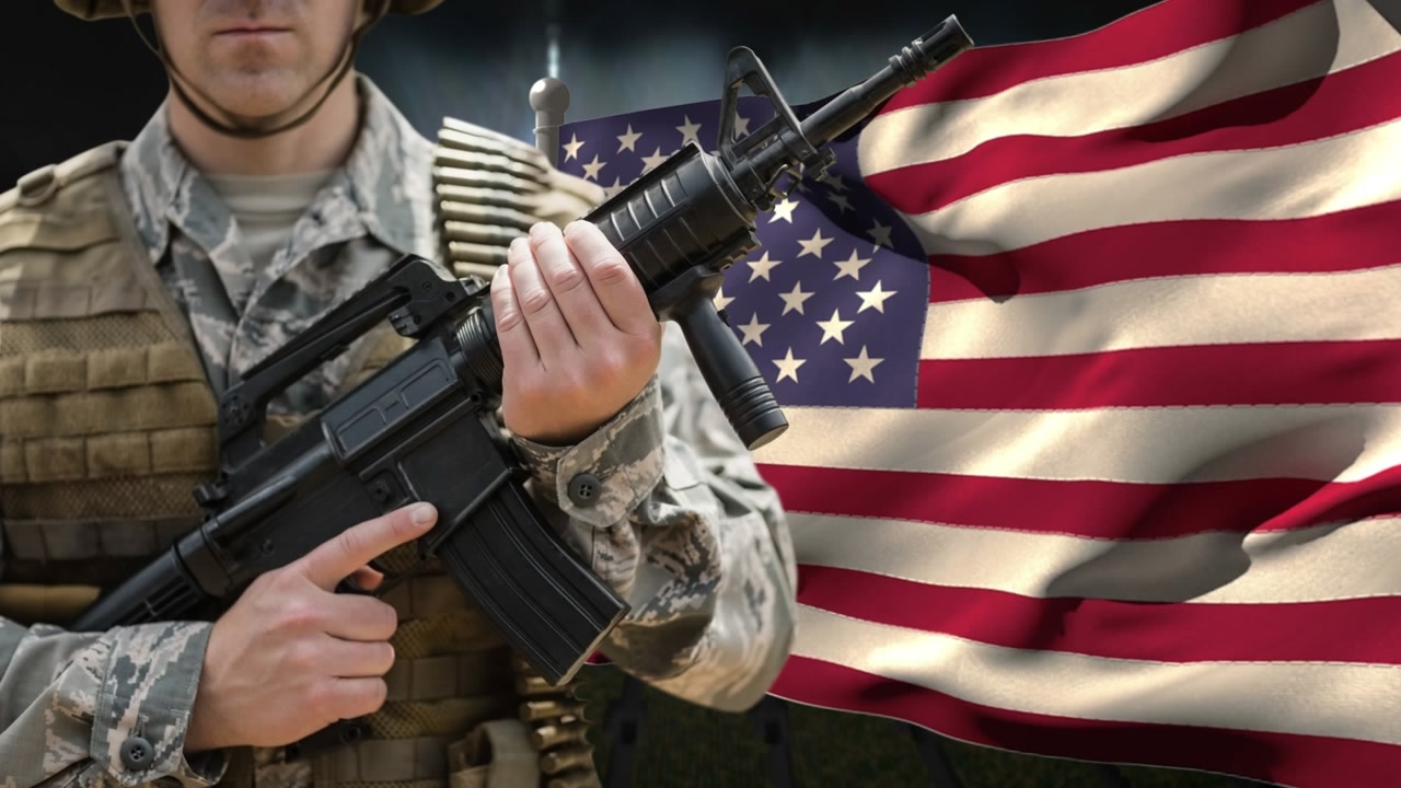 Animation of american flag over caucasian male soldier with weapon