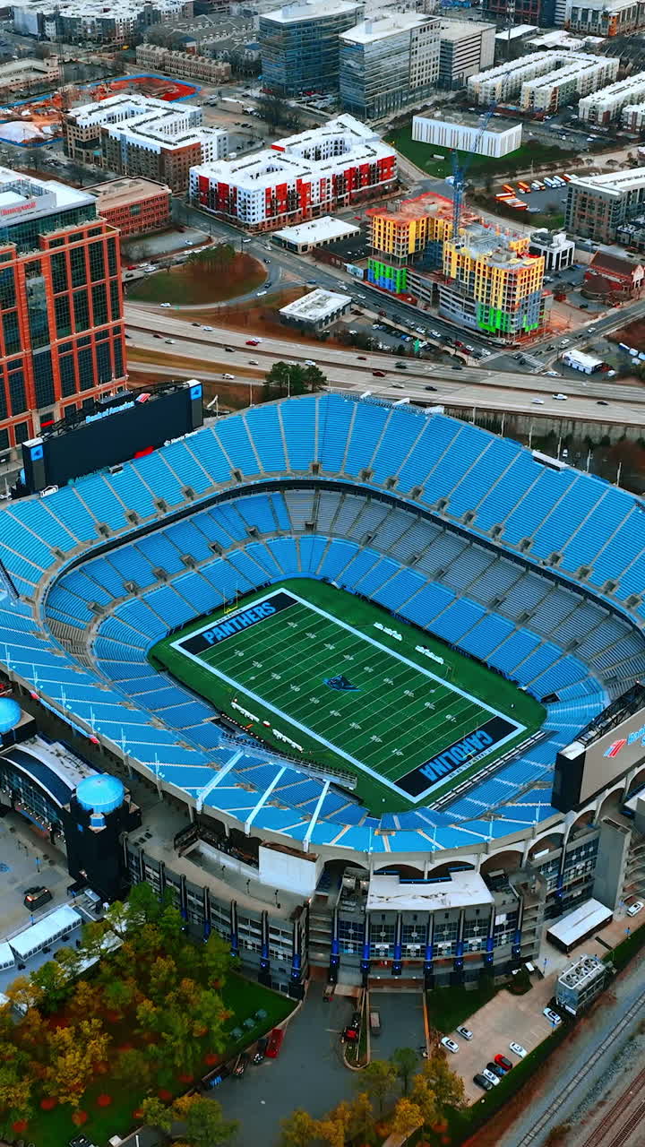 Approaching the stadium structure in the downtown of Charlotte, North Carolina, USA. Urban cityscape from drone footage. Vertical video