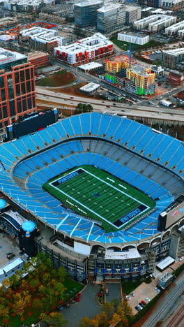 approaching the stadium structure in the downtown of charlotte, north carolina, usa. urban cityscape from drone footage. vertical video
