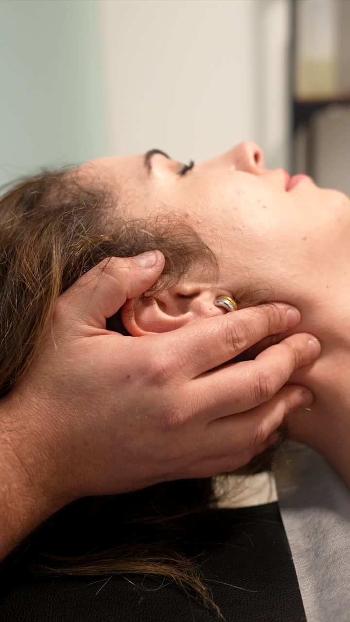 Close-Up of Therapist's Hands Massaging Woman's Neck