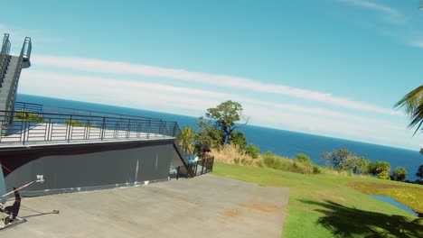 Fast-Paced-FPV-follow-upshot-of-a-tourist-golfer-playing-golf-on-the-Big-Island-in-Hawaii-surrounded-by-lush-green-foliage-and-greenery-and-leading-to-the-Pacific-Ocean-4K-UHD