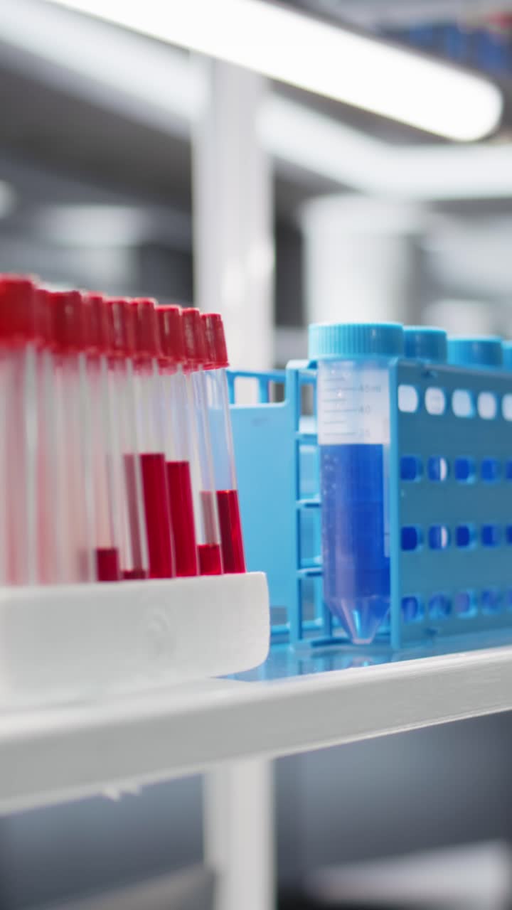 Vertical video Close up of blood samples in test tubes and reagent solutions