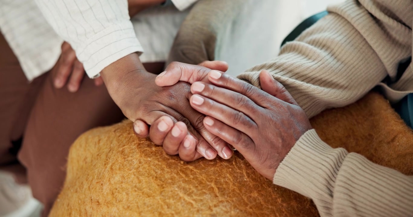 Close-up of Two People Holding Hands for Comfort and Support