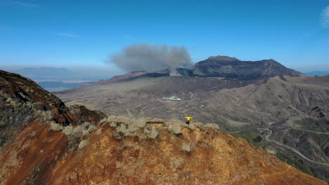 wide revealing drone shot of mountain range near the volcano mount aso