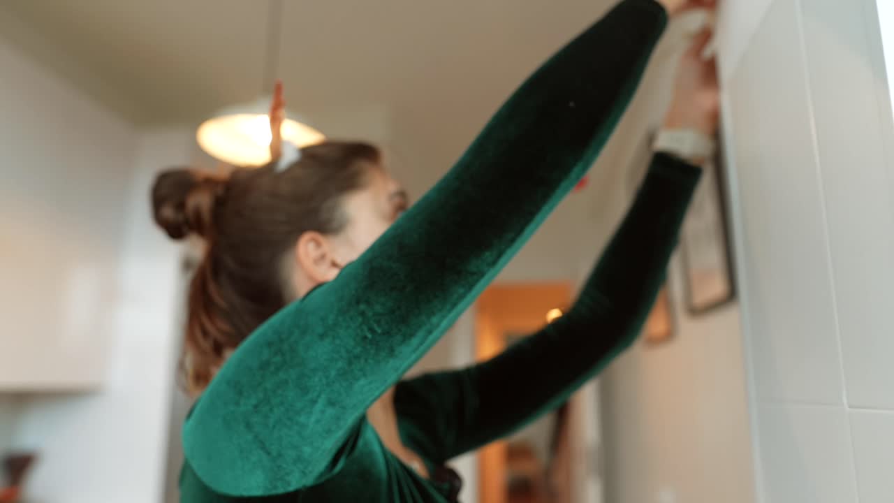 Woman Decorating Kitchen for Christmas
