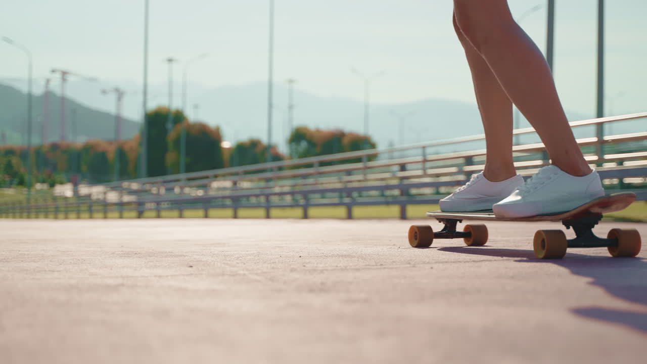 Woman Skateboarding on Longboard in City Park