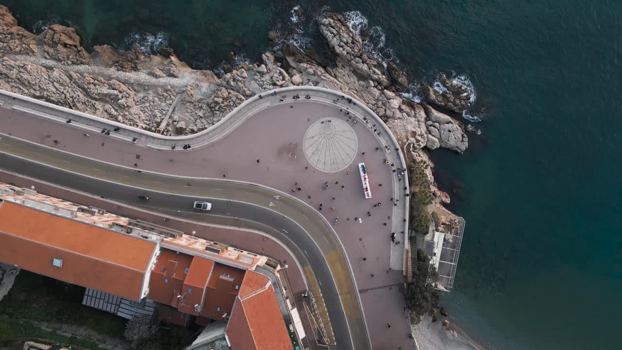 vista aérea de drones de personas contemplando el tranquilo mar mediterráneo azul en la riviera francesa al atardecer