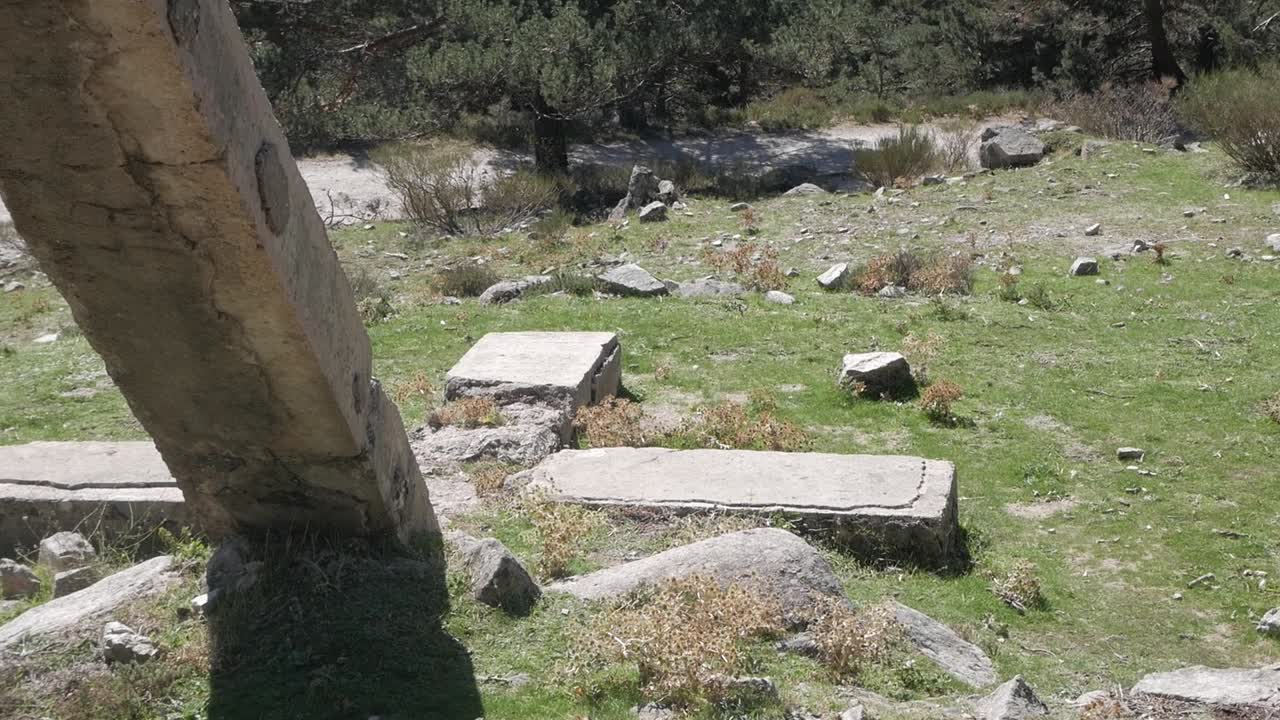 Remote stone house in the hills of Madrid surrounded by bushes and scattered rocks