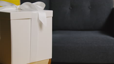 Close-Up-Of-Gift-Wrapped-Present-With-Bow-On-Table-In-Lounge-At-Home-1