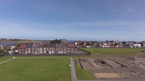 stone gateway of arbeia, south shields roman fort with river tyne in background in south shields, england, uk.- aerial