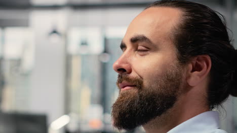 trader with smile on face in office looks upward, visualizing financial success