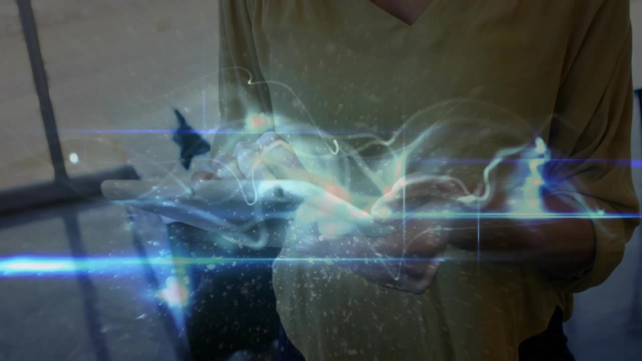 Mid-adult woman tapping tablet screen and generating swirling holographic lines for technology demo