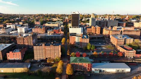 rising aerial reveals historic downtown lynchburg, virginia, usa during autumn golden magic hour