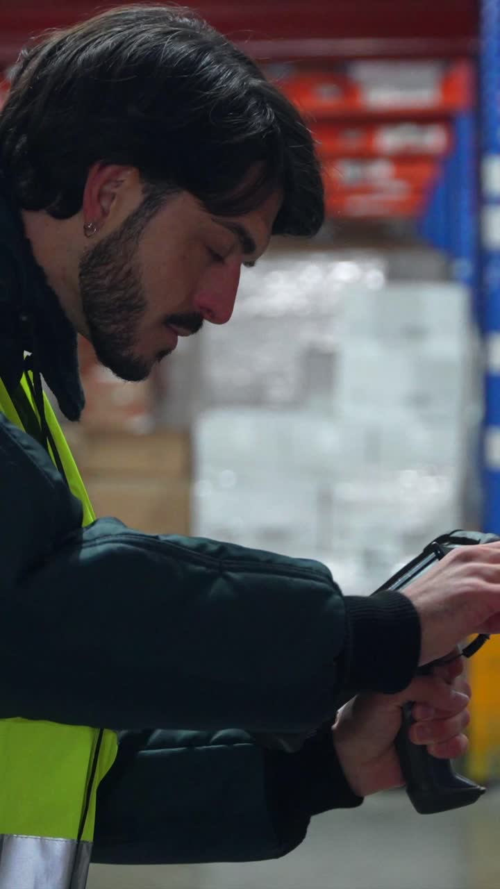 Worker scanning inventory in a warehouse