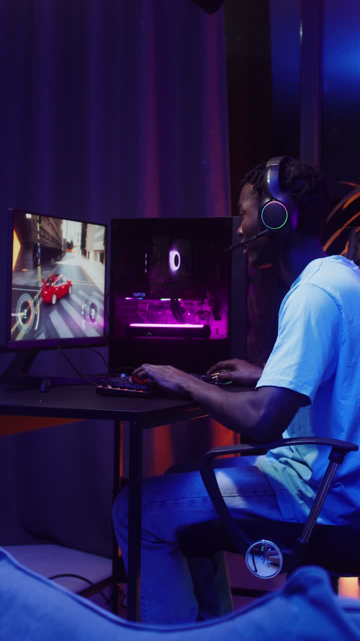 Man playing a racing simulator game on his computer