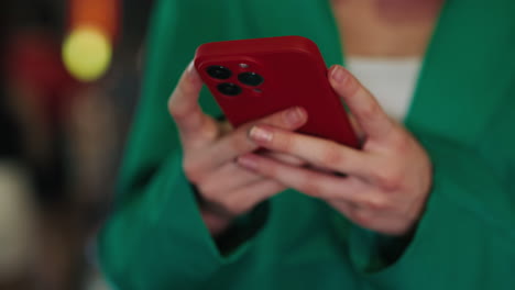 woman using red smartphone