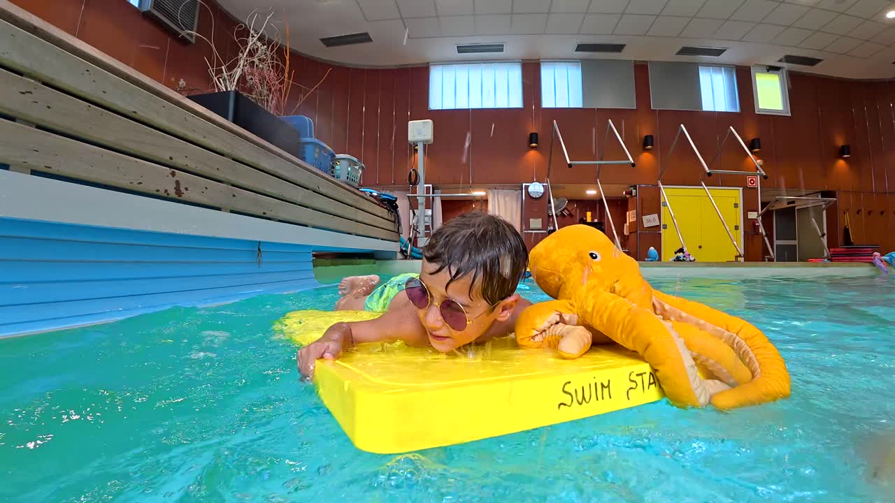 Child Having Fun Swimming in a Pool