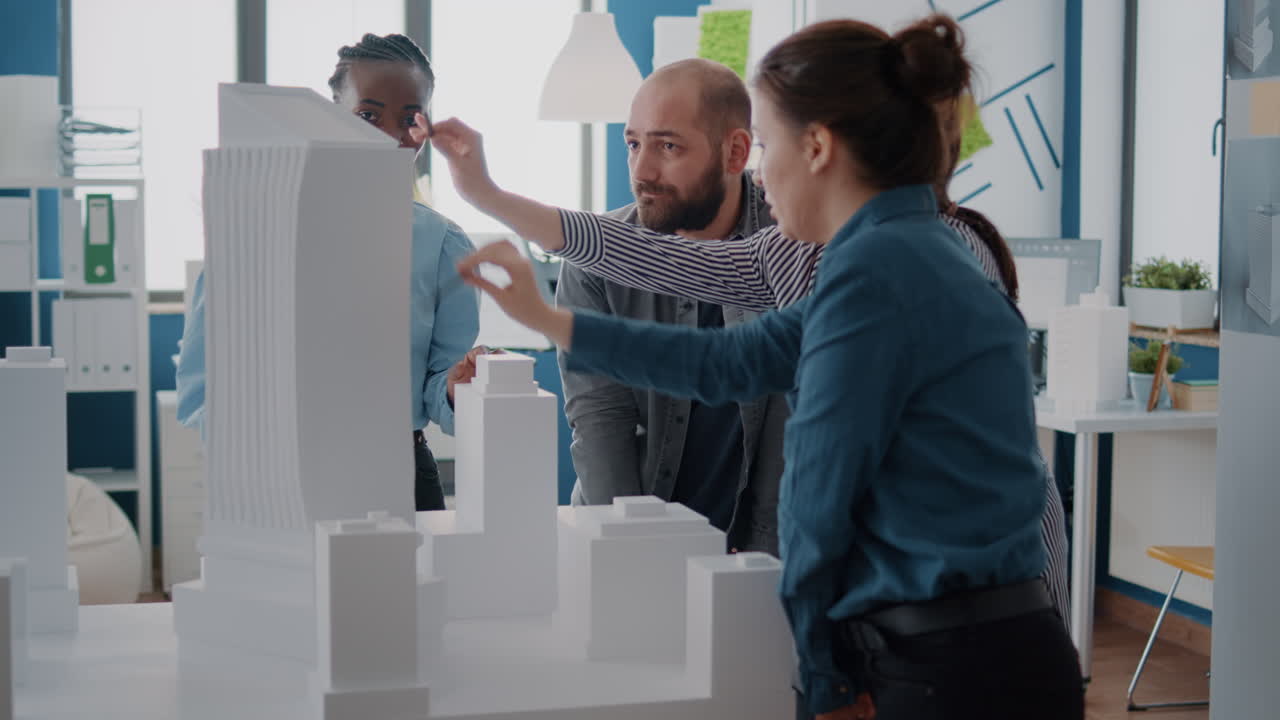 Architects collaborating on a building model in an office