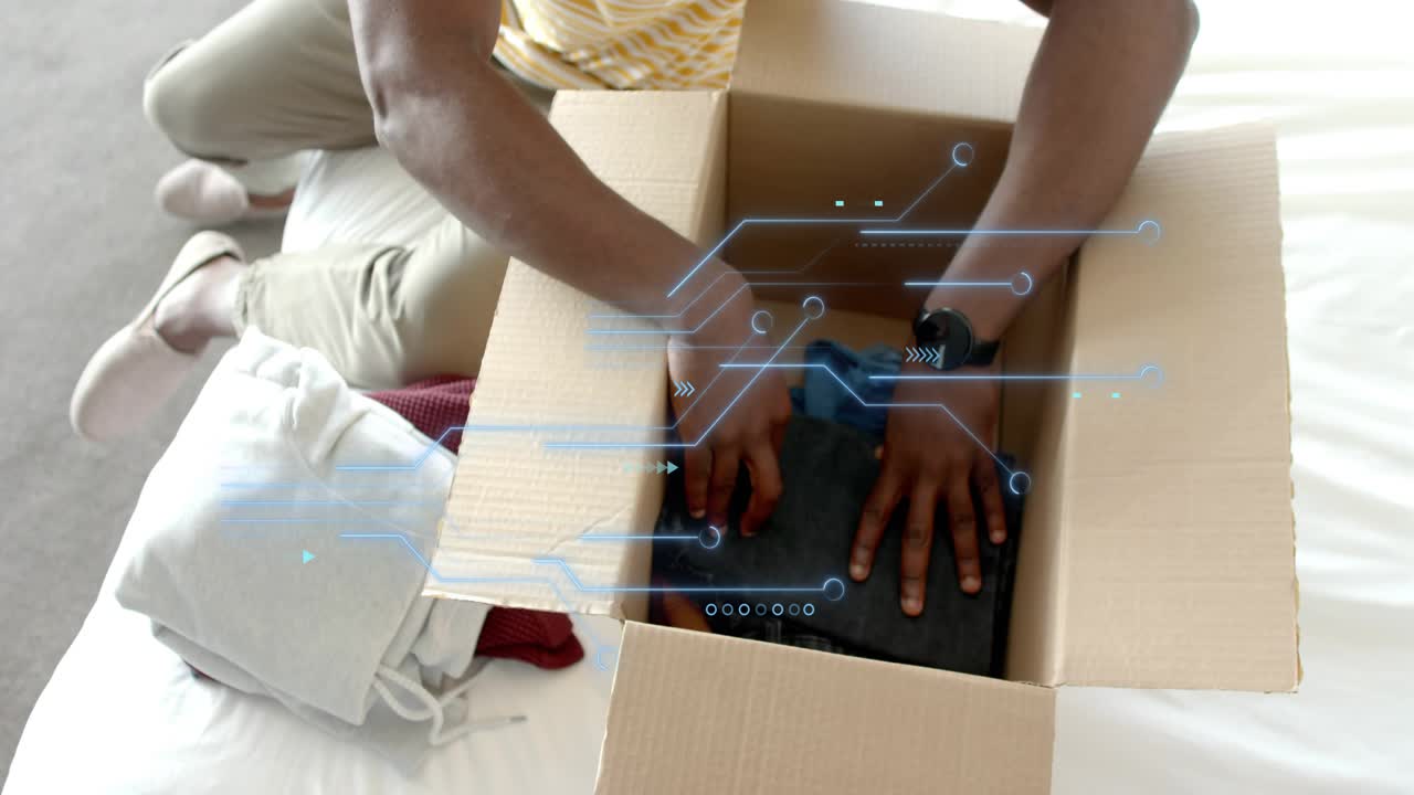 Man on bed initiating packing into box to ship, inspecting blue shirt, folding jeans, HUD scanning