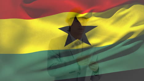 animation of flag of ghana, caucasian engineer wearing helmet standing with blueprints