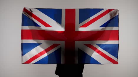 person holding the union jack flag