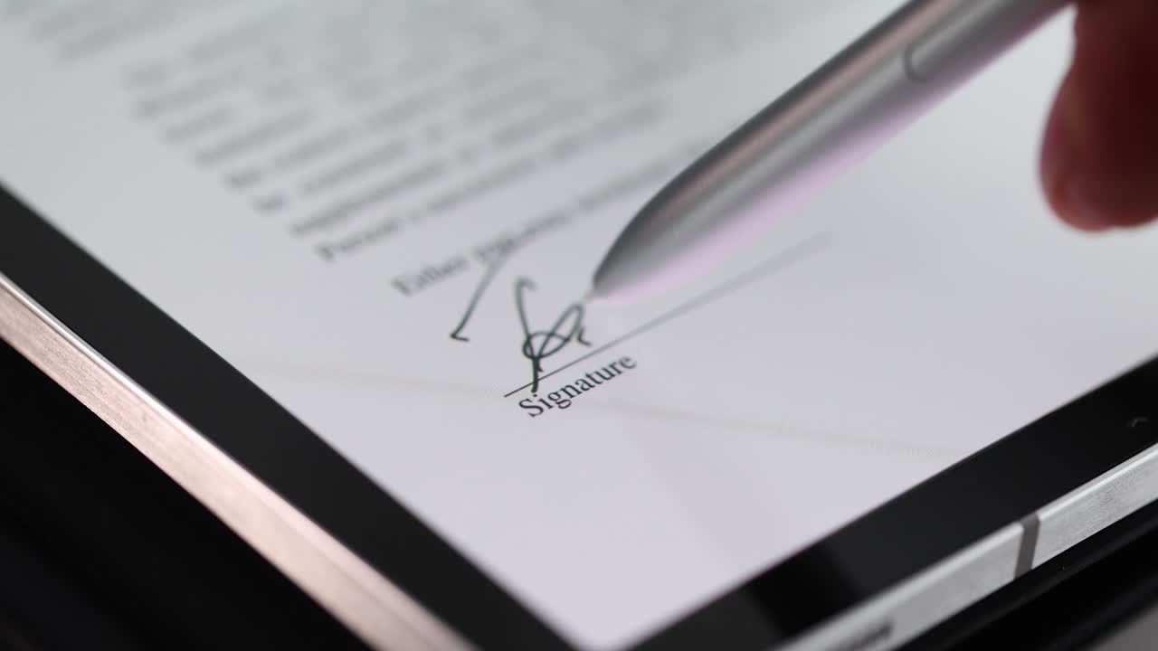 Female hand signing contract on digital tablet using stylus closeup 4k movie slow motion